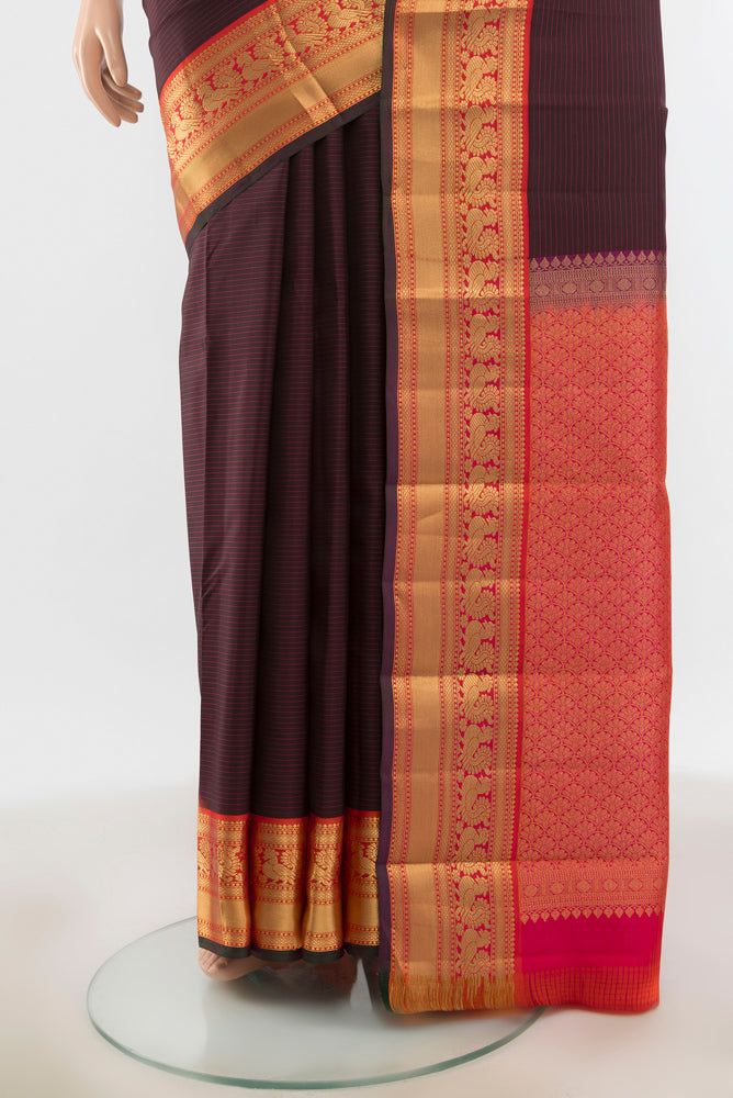 Pleats and pallu of Brown Kanchipuram Silk Saree with Zari Butta on the body and Silk Border. 