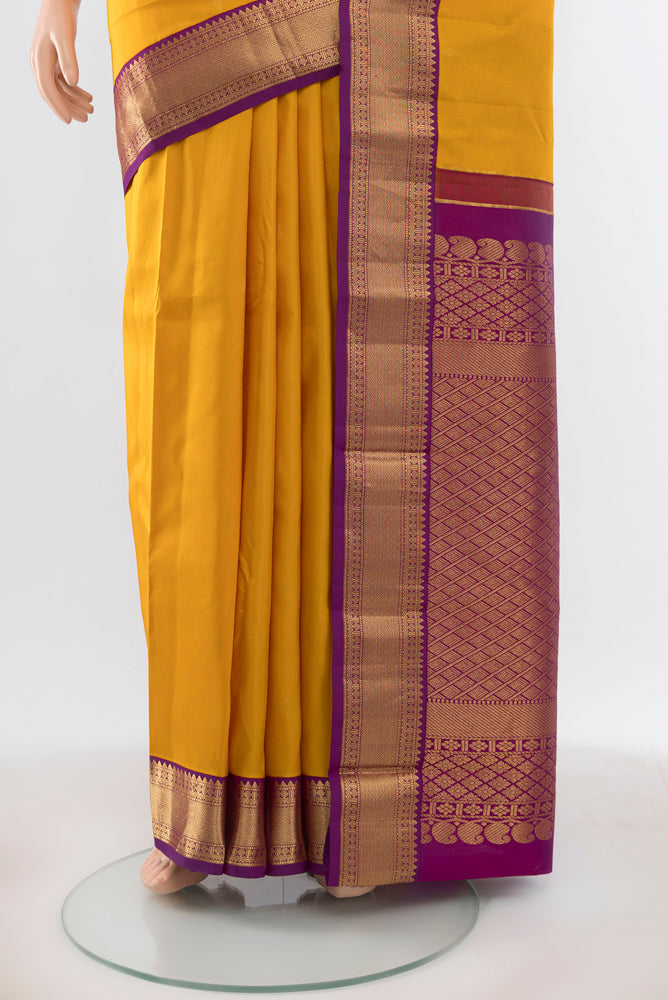 Pleats and pallu of Pure Silk Pure Zari Yellow Kanchipuram Saree with Zari Butta on the body and Silk Border. 