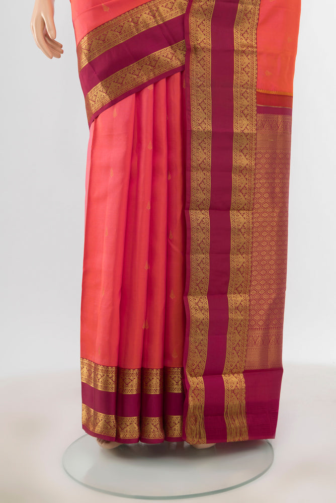 Pleats and pallu of Pure Silk Pure Zari Peach Kanchipuram Saree with Zari Butta on the body and Silk Border. 