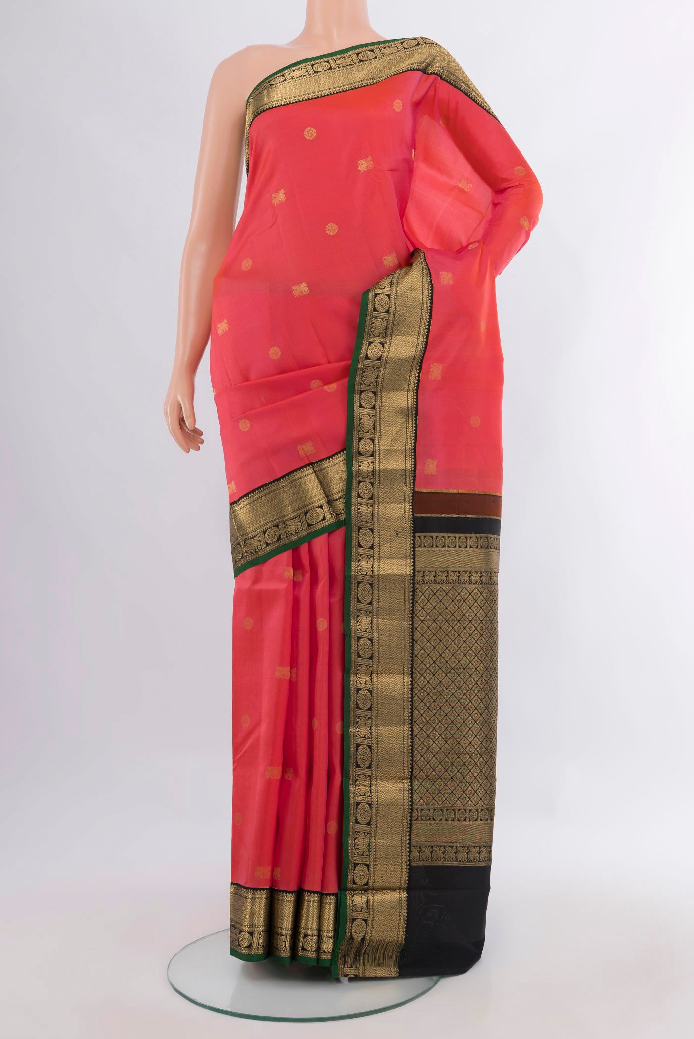 Pure Silk Coral Kanchipuram Saree with Zari Butta on the body and Zari Border.  displayed on a mannequin