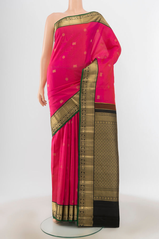 Peach Kanchipuram Silk Saree with Zari Butta on the body and Silk Border.  displayed on a mannequin