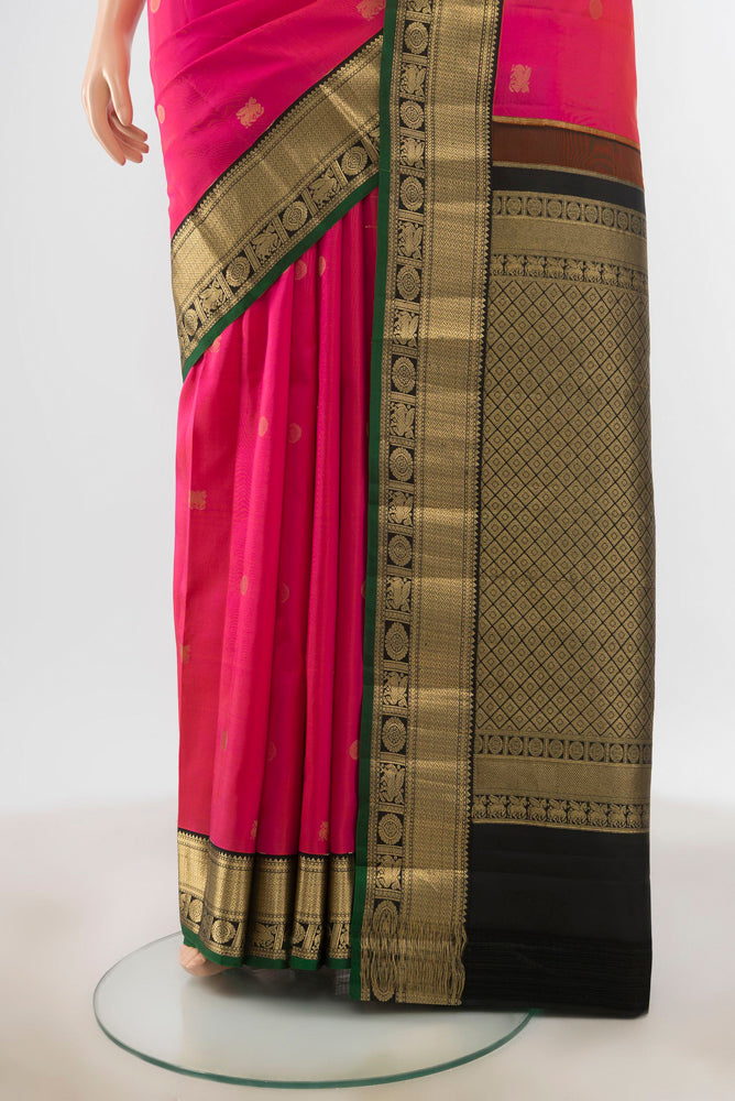 Pleats and pallu of Peach Kanchipuram Silk Saree with Zari Butta on the body and Silk Border. 
