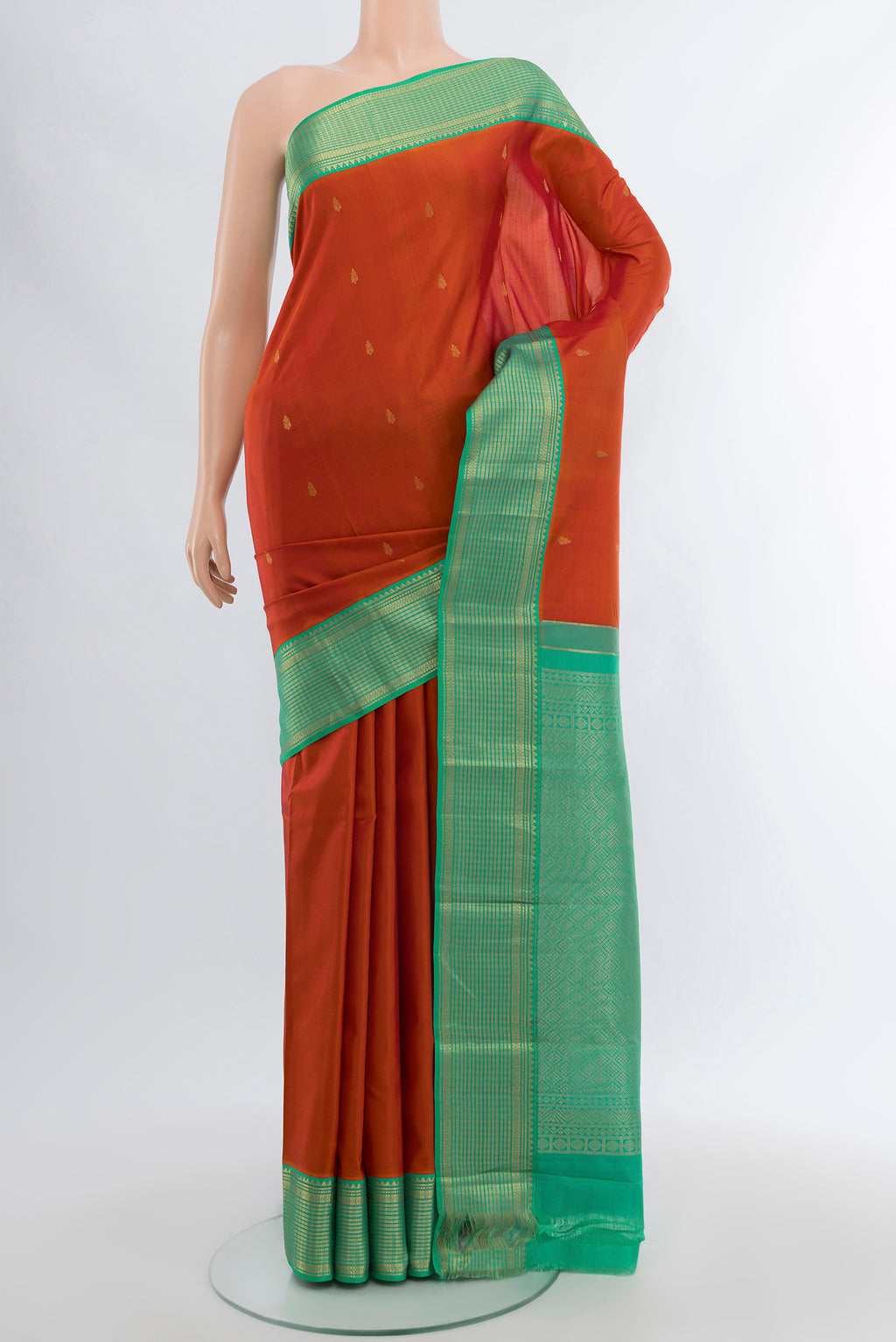 Peach Kanchipuram Silk Saree with Zari Butta on the body and Silk Border.  displayed on a mannequin