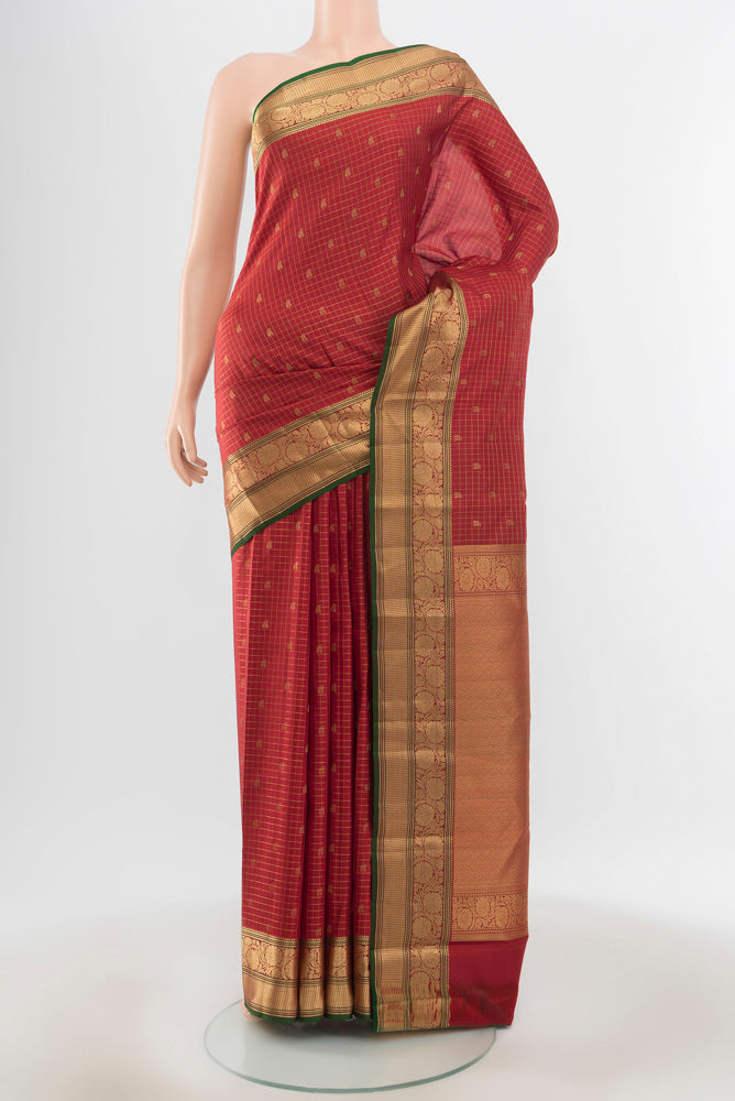 Pure Silk Pure Zari Maroon Kanchipuram Saree with Zari Butta on the body and Silk Border.  displayed on a mannequin
