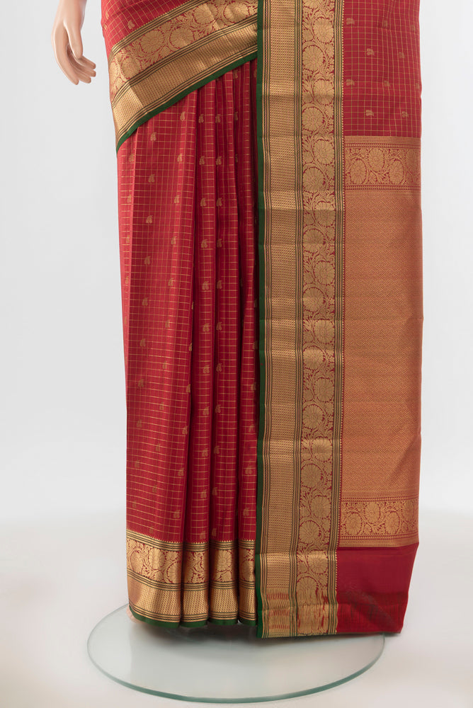 Pleats and pallu of Pure Silk Pure Zari Maroon Kanchipuram Saree with Zari Butta on the body and Silk Border. 