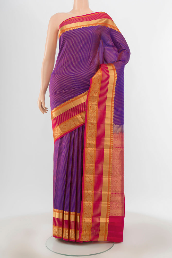 Pure Silk Pure Zari Purple Kanjivaram Saree with Zari Butta on the body and Silk Border.  displayed on a mannequin
