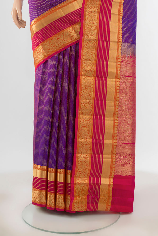 Pleats and pallu of Pure Silk Pure Zari Purple Kanjivaram Saree with Zari Butta on the body and Silk Border. 