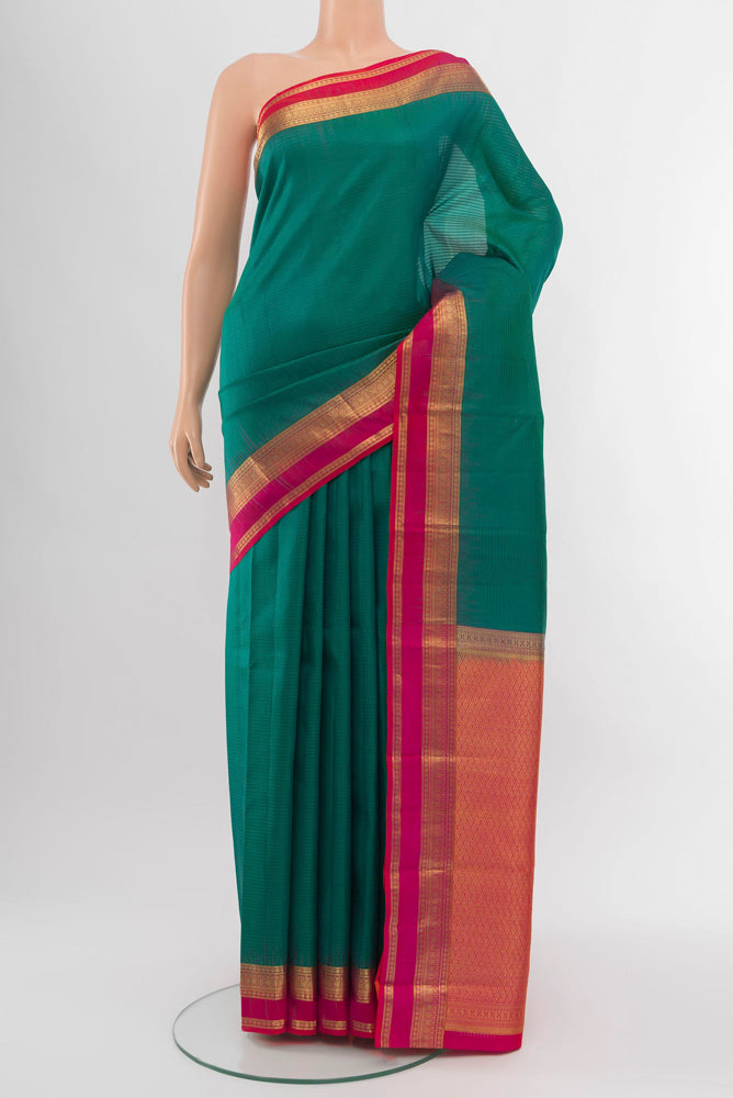 Peacock Blue Kanchipuram Silk Saree with Zari Brocade on the body and Silk Border.  displayed on a mannequin