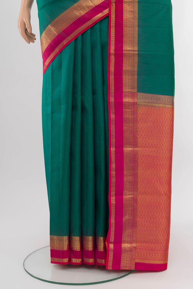 Pleats and pallu of Peacock Blue Kanchipuram Silk Saree with Zari Brocade on the body and Silk Border. 