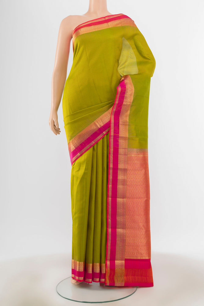 Light Green Kanchipuram Silk Saree with Zari Butta on the body and Silk Border.  displayed on a mannequin
