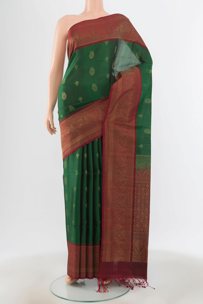 Bottle Green Soft Silk Saree with Zari Brocade on the body and Silk Border.  displayed on a mannequin