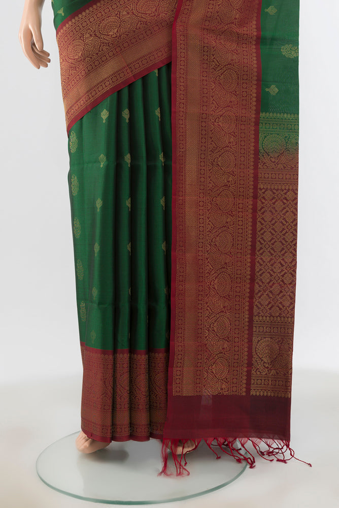 Pleats and pallu of Bottle Green Soft Silk Saree with Zari Brocade on the body and Silk Border. 