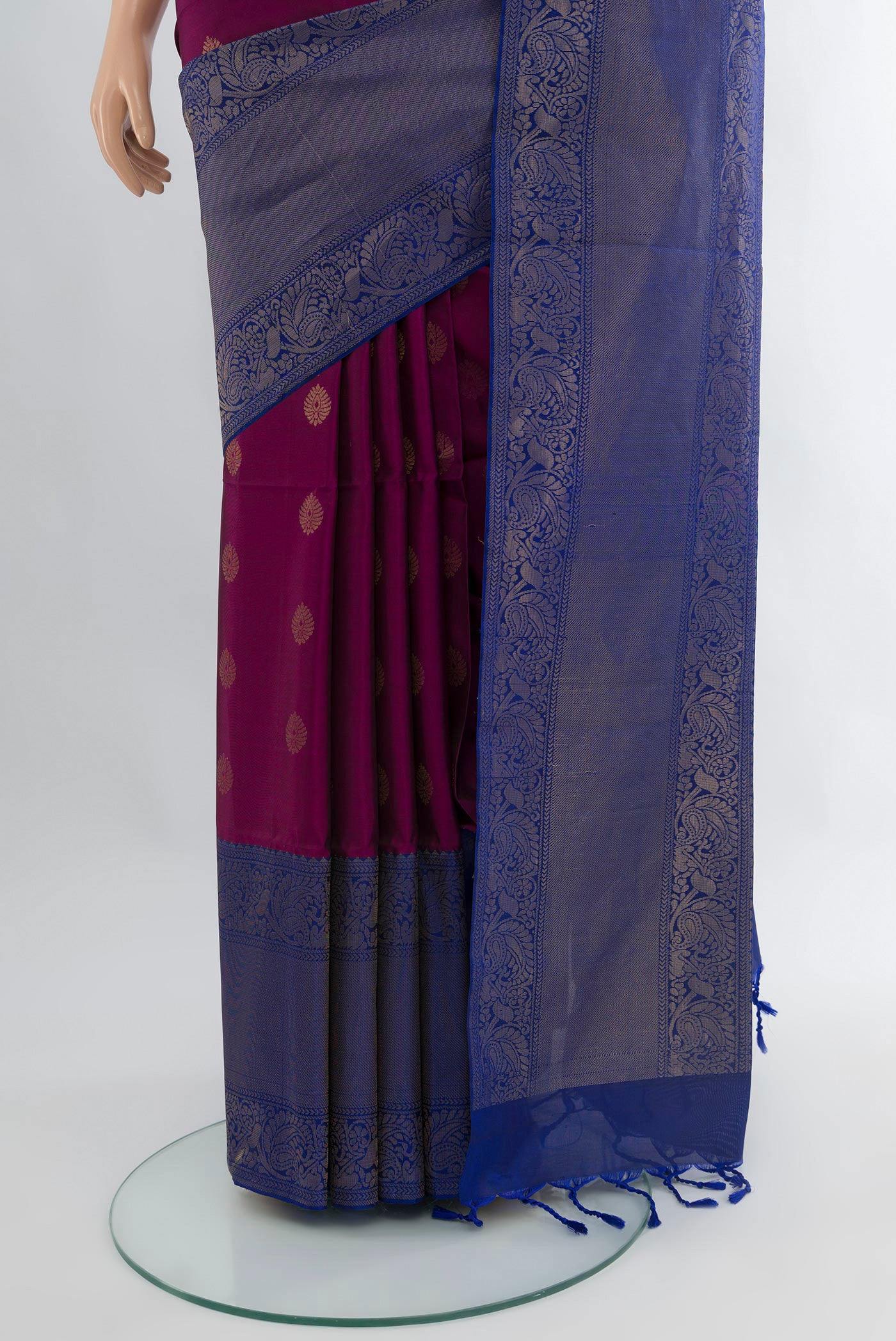Pleats and pallu of Purple Soft Silk Saree with Zari Butta on the body and One Side Border. 