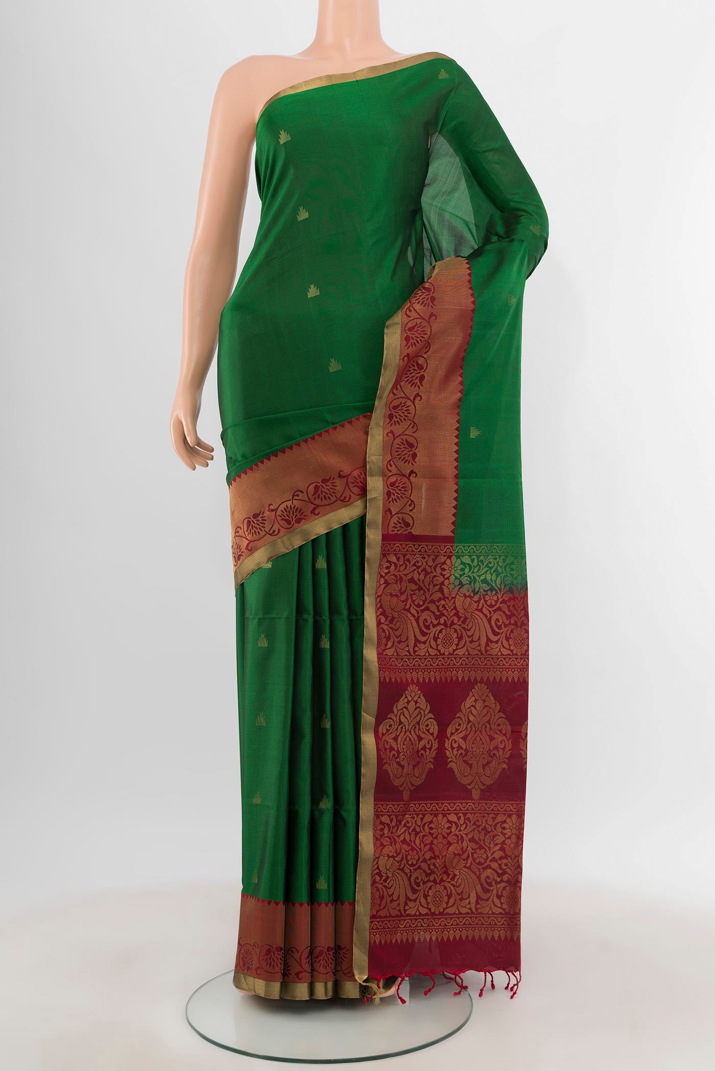 Green Soft Silk Saree with Zari Butta on the body and Zari Border.  displayed on a mannequin