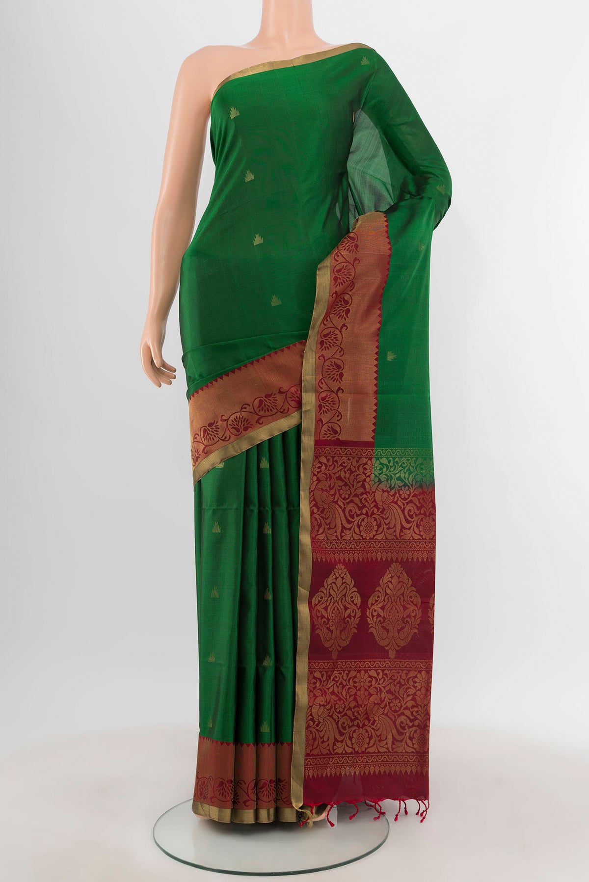 Green Soft Silk Saree with Zari Butta on the body and Zari Border.  displayed on a mannequin