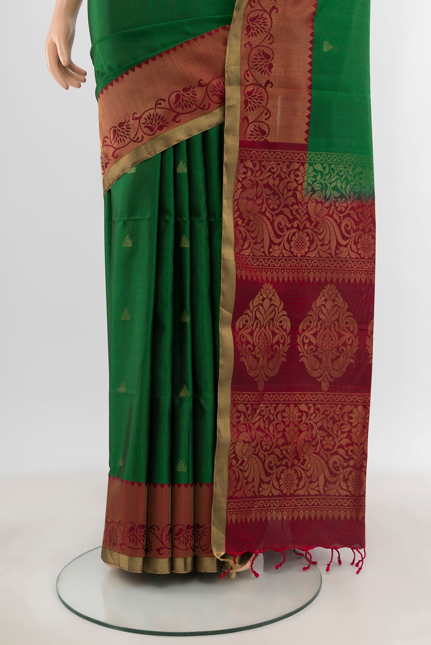 Pleats and pallu of Green Soft Silk Saree with Zari Butta on the body and Zari Border. 