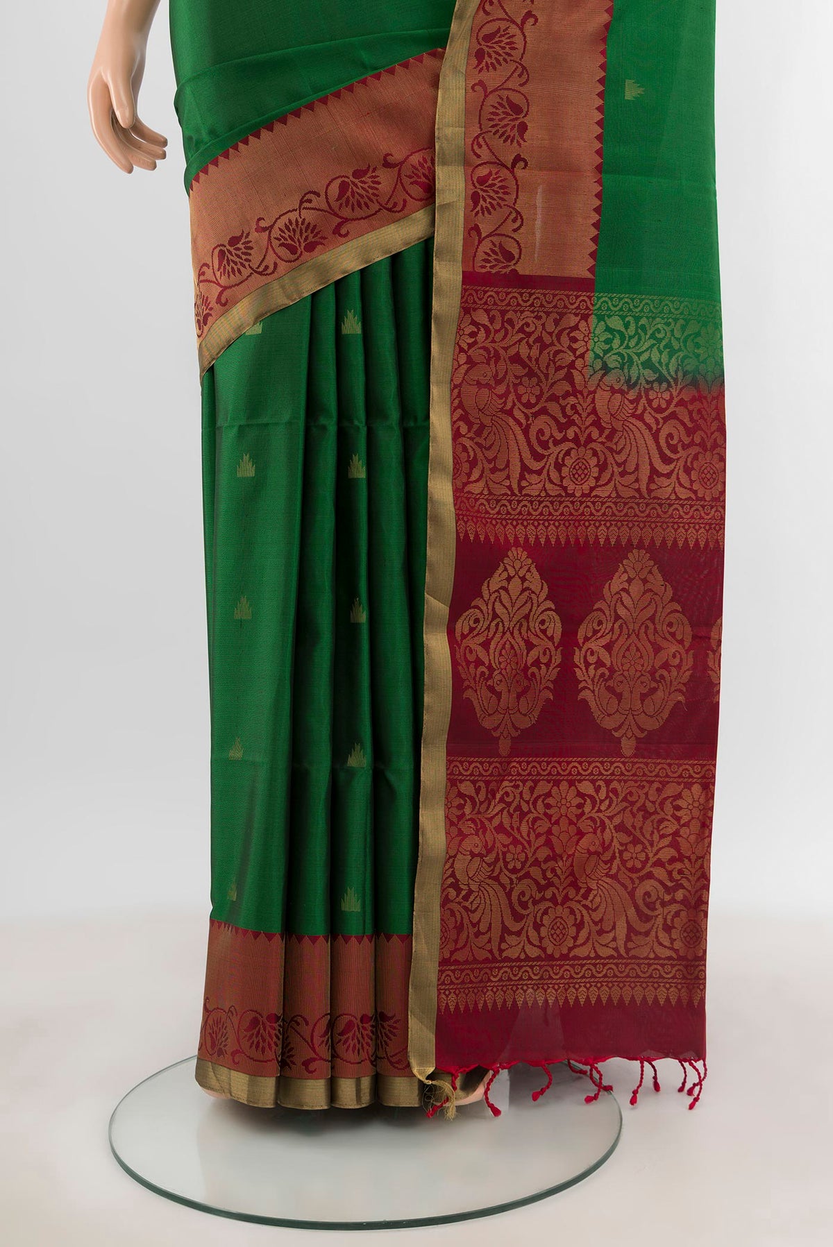 Pleats and pallu of Green Soft Silk Saree with Zari Butta on the body and Zari Border. 