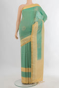 Pure Silk Light Green Soft Saree with Zari Butta on the body and Zari Border.  displayed on a mannequin