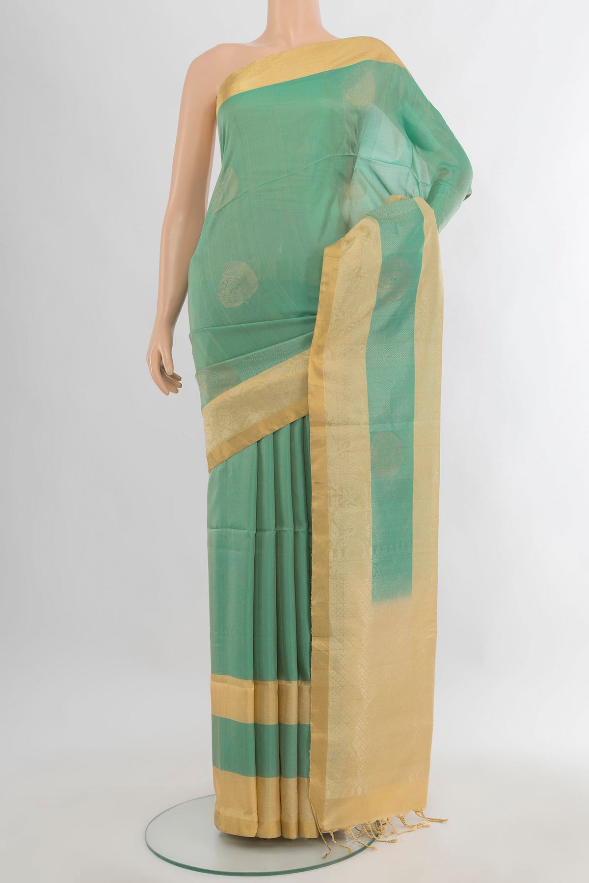 Pure Silk Light Green Soft Saree with Zari Butta on the body and Zari Border.  displayed on a mannequin
