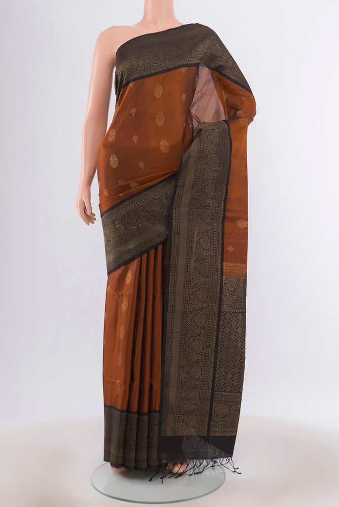 Rust Soft Silk Saree with Zari Butta on the body and Silk Border.  displayed on a mannequin