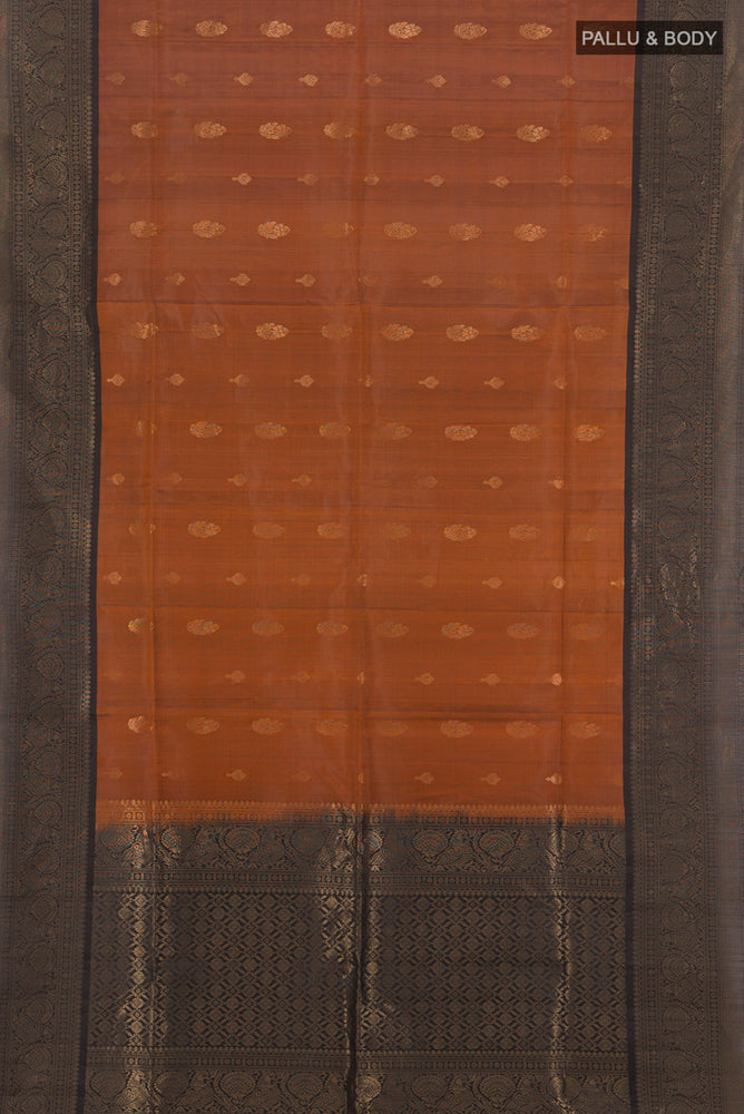 Flat view of Rust Soft Silk Saree with Zari Butta on the body and Silk Border. 