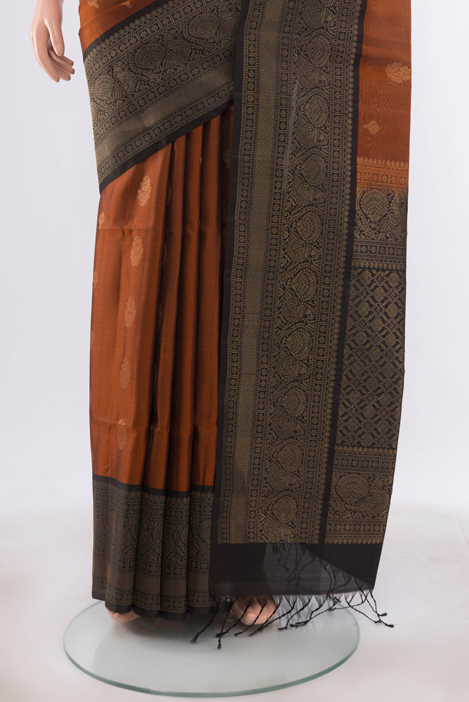 Pleats and pallu of Rust Soft Silk Saree with Zari Butta on the body and Silk Border. 
