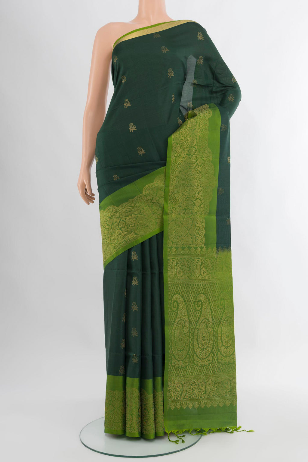 Bottle Green Soft Silk Saree with Zari Butta on the body and Zari Border.  displayed on a mannequin