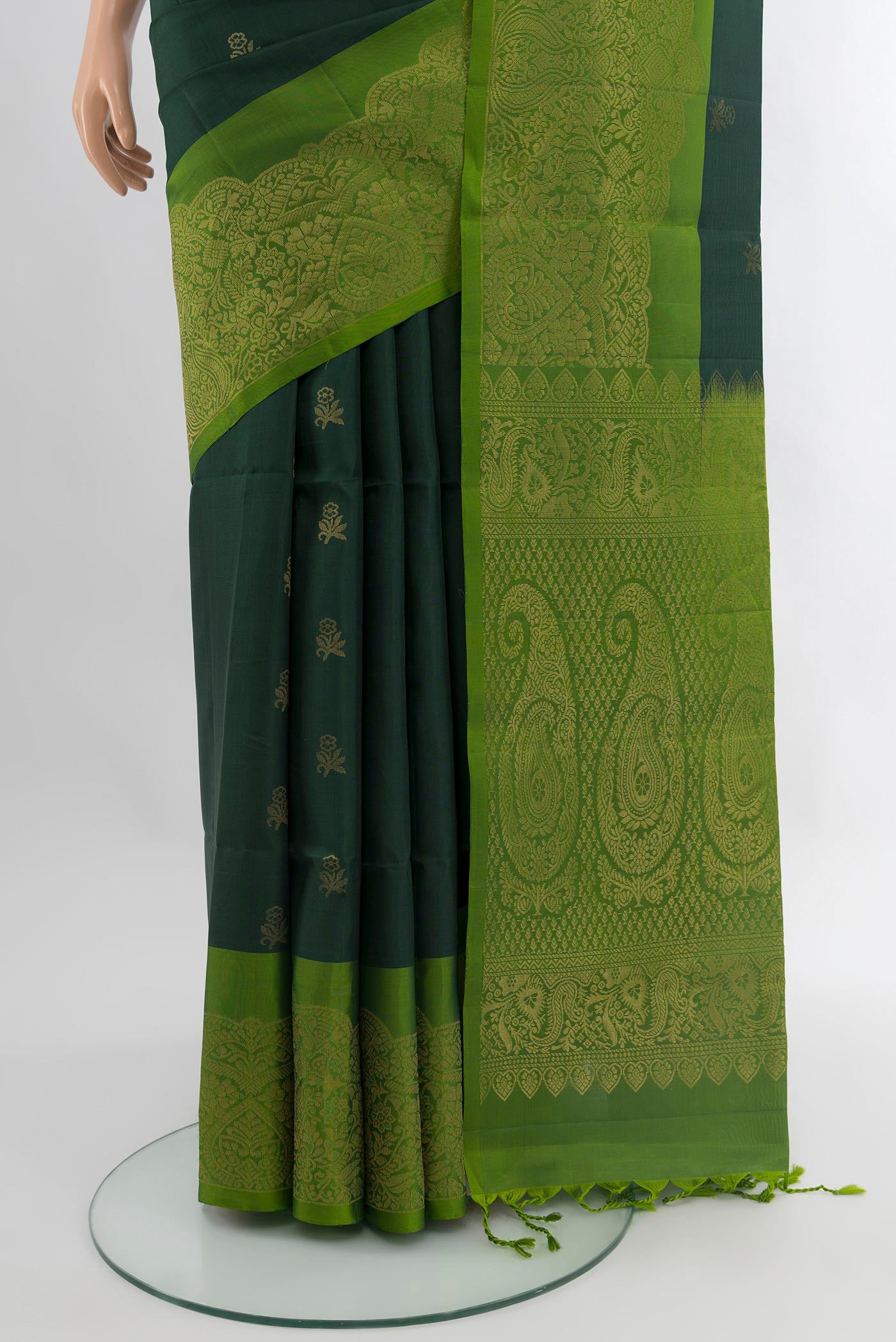 Pleats and pallu of Bottle Green Soft Silk Saree with Zari Butta on the body and Zari Border. 
