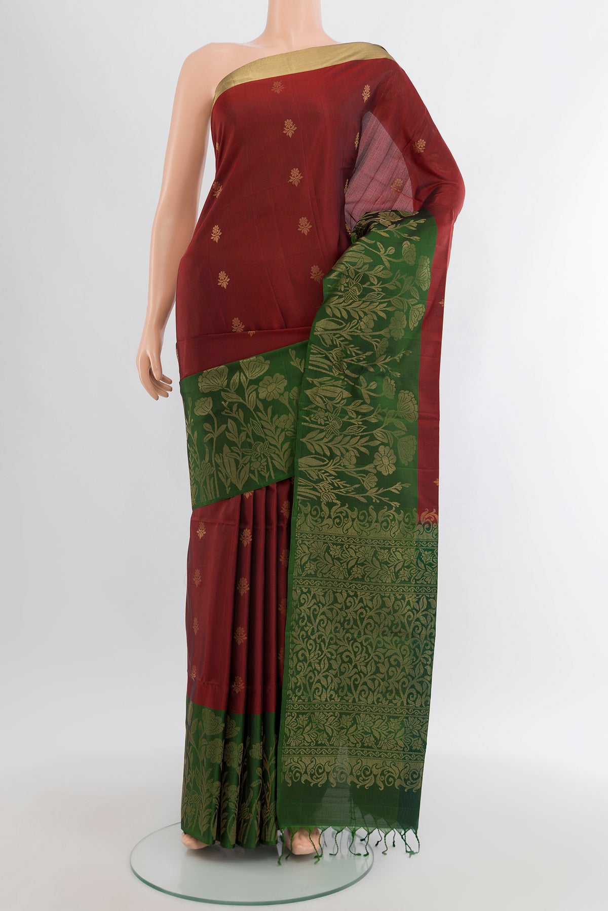 Maroon Soft Silk Saree with Zari Butta on the body and Zari Border.  displayed on a mannequin