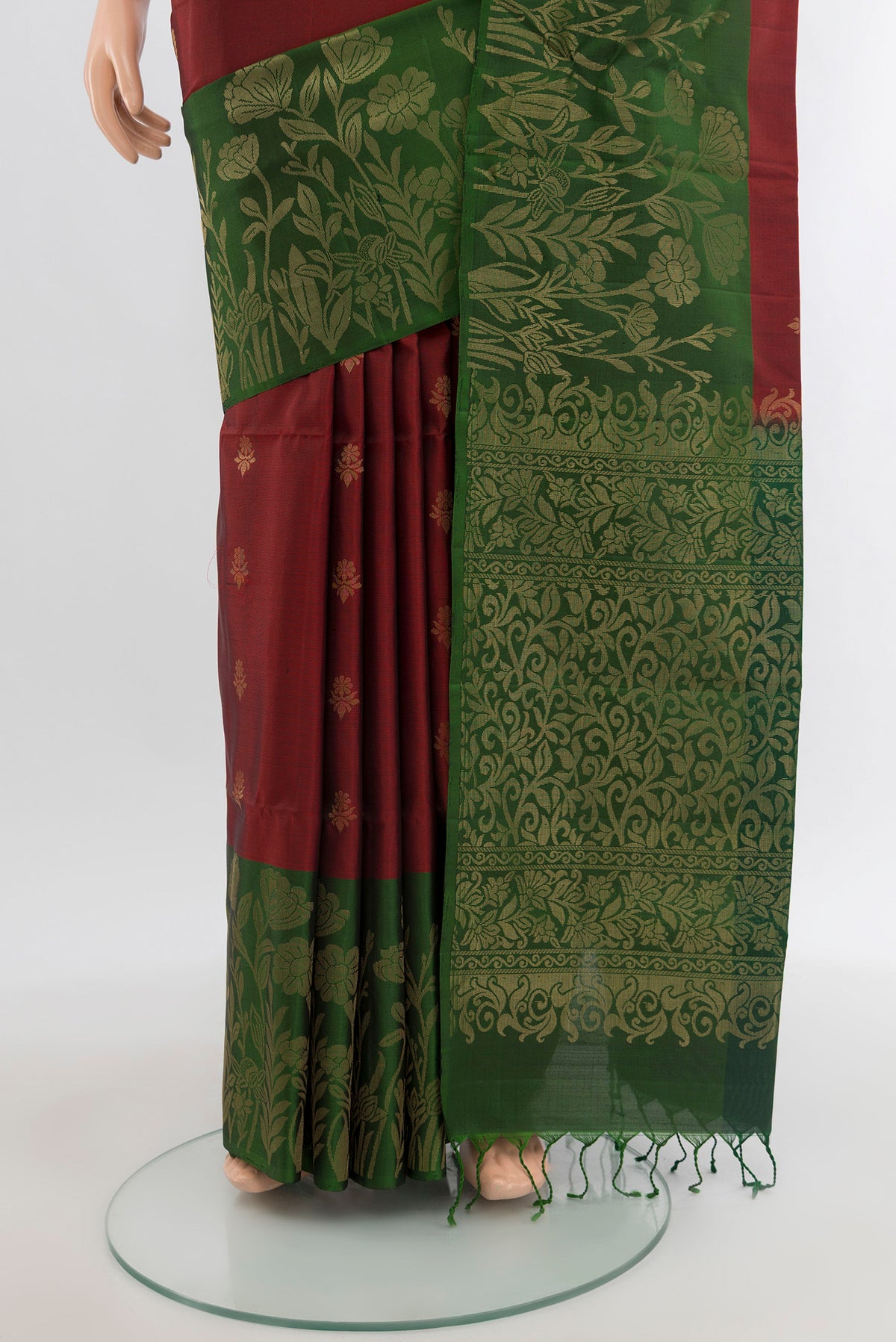 Pleats and pallu of Maroon Soft Silk Saree with Zari Butta on the body and Zari Border. 