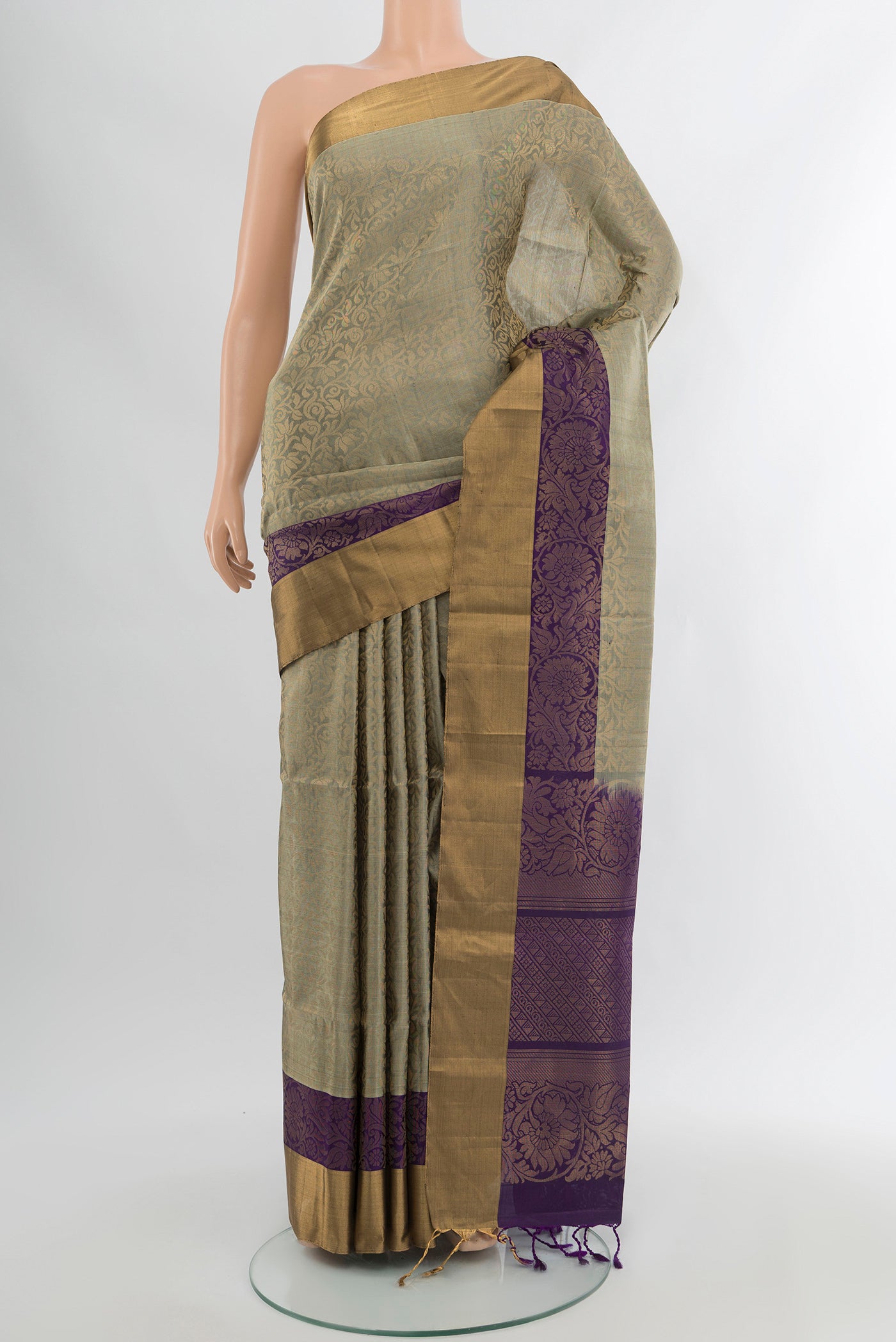 Grey Soft Silk Saree with Zari Butta on the body and Silk Border.  displayed on a mannequin
