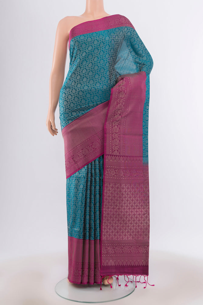 Peacock Blue Soft Silk Saree with Zari Butta on the body and Silk Border.  displayed on a mannequin