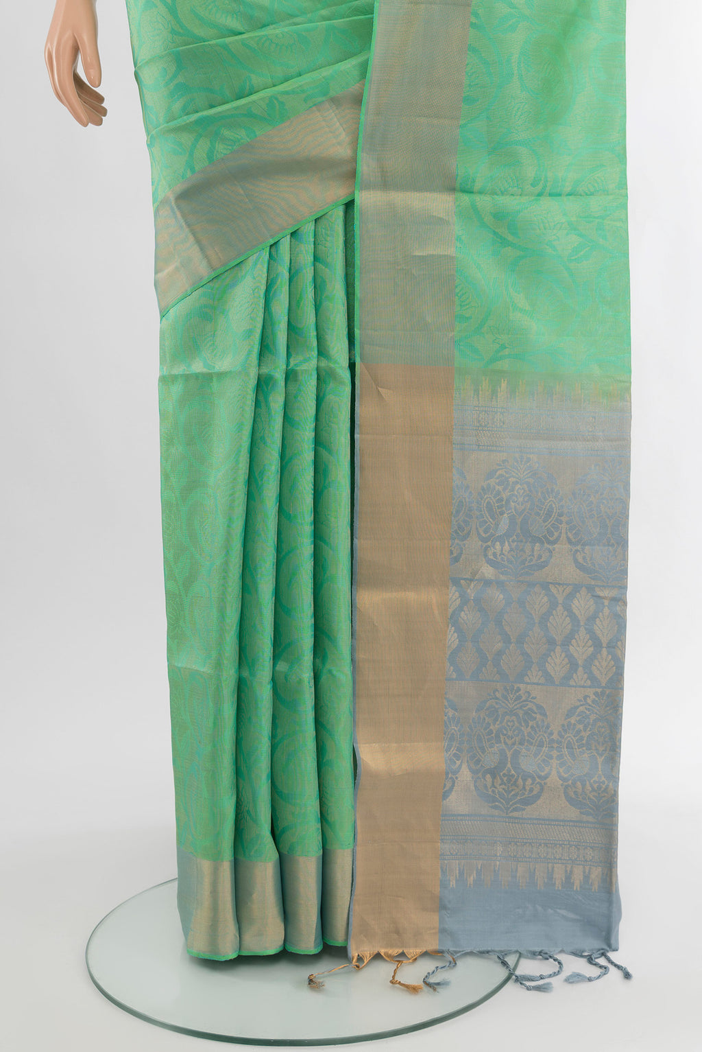 Pleats and pallu of Light Green Soft Silk Saree with Zari Butta on the body and Silk Border. 