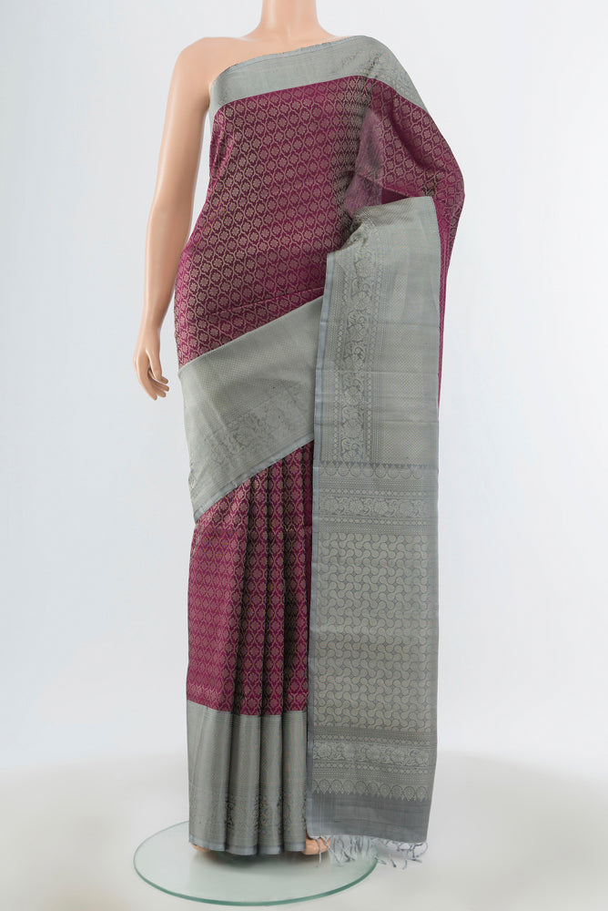 Purple Soft Silk Saree with Zari Butta on the body and Silk Border.  displayed on a mannequin