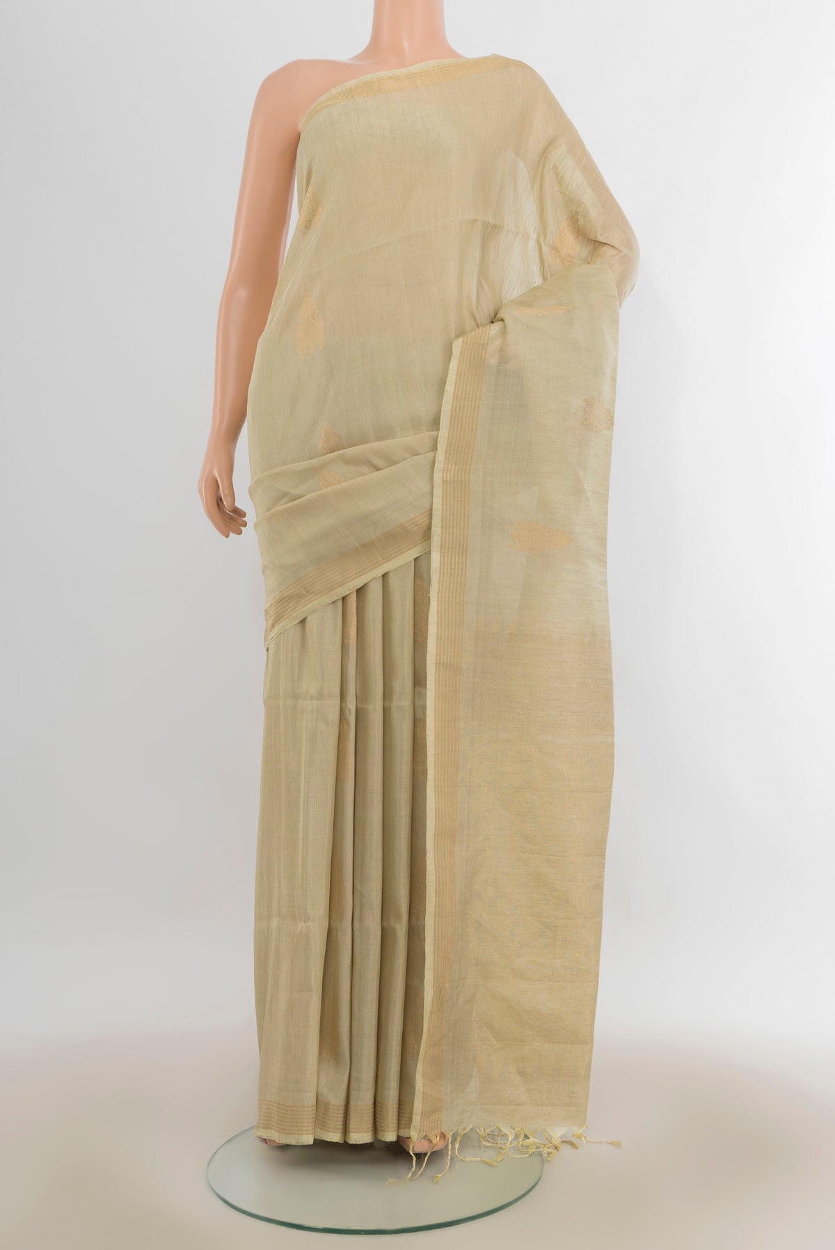 Pure Silk Beige Soft Saree with Zari Butta on the body and Zari Border.  displayed on a mannequin