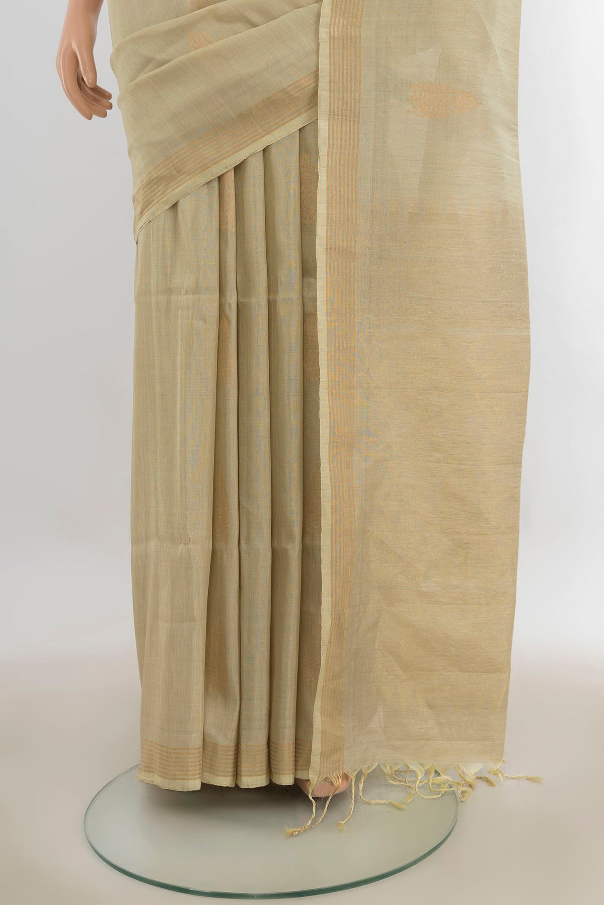 Pleats and pallu of Pure Silk Beige Soft Saree with Zari Butta on the body and Zari Border. 