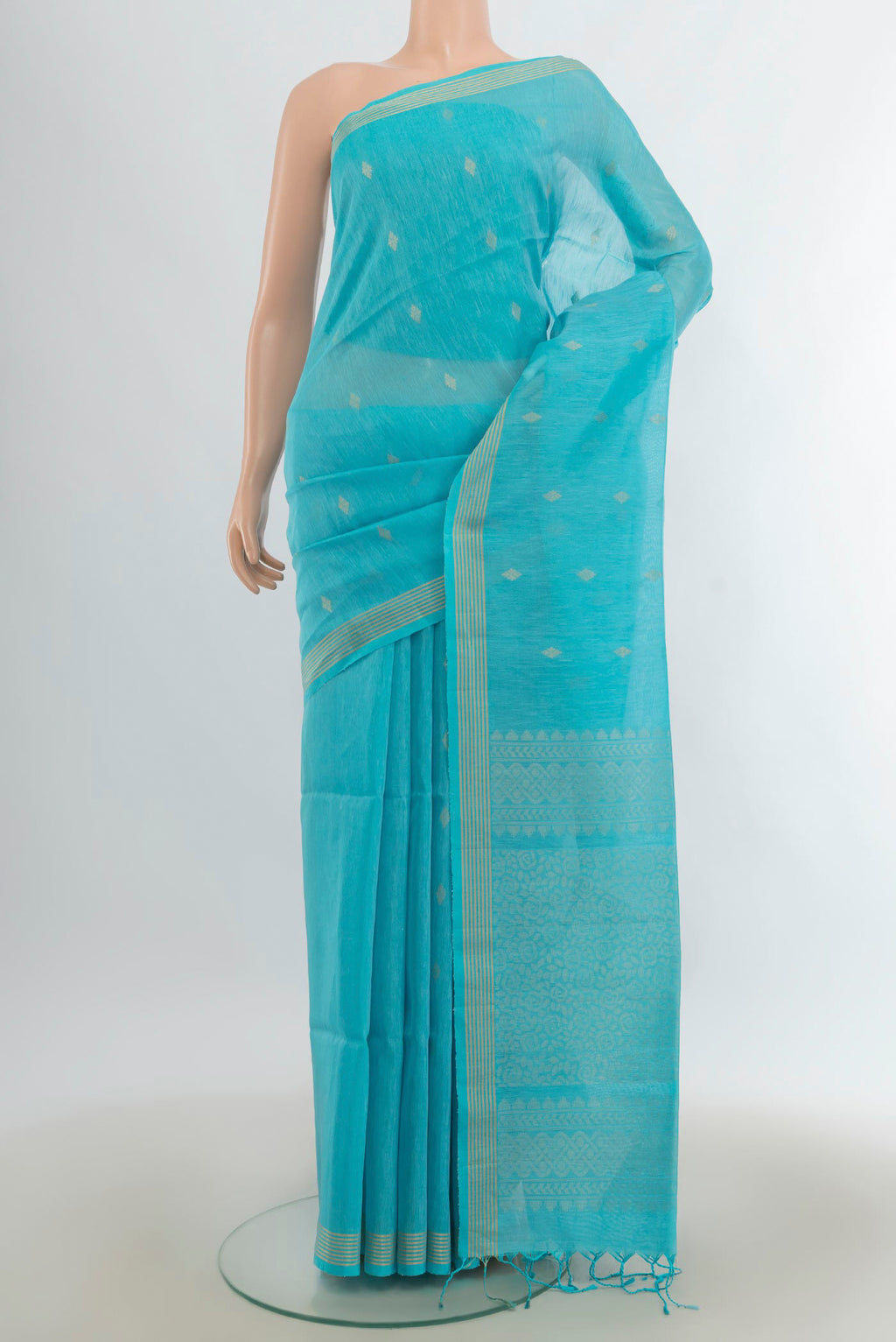 Light Blue Soft Saree with Zari Butta on the body and Silk Border.  displayed on a mannequin