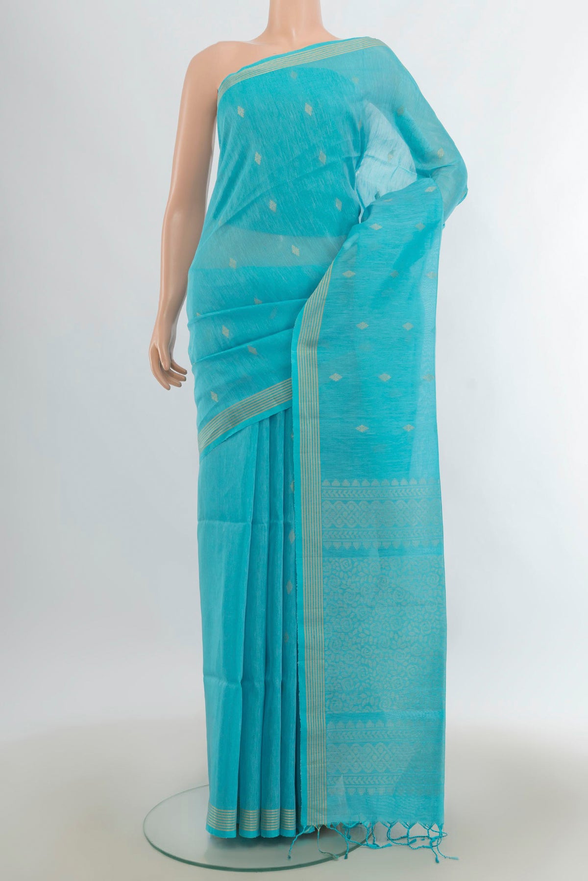 Light Blue Soft Saree with Zari Butta on the body and Silk Border.  displayed on a mannequin