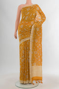 Mustard Maheshwari Silk Cotton Saree with Floral Print on the body and Zari Border.  displayed on a mannequin