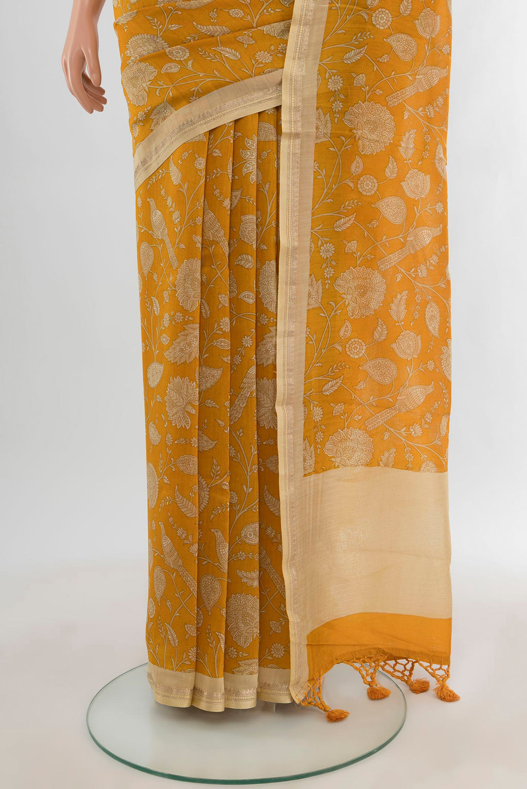 Pleats and pallu of Mustard Maheshwari Silk Cotton Saree with Floral Print on the body and Zari Border. 