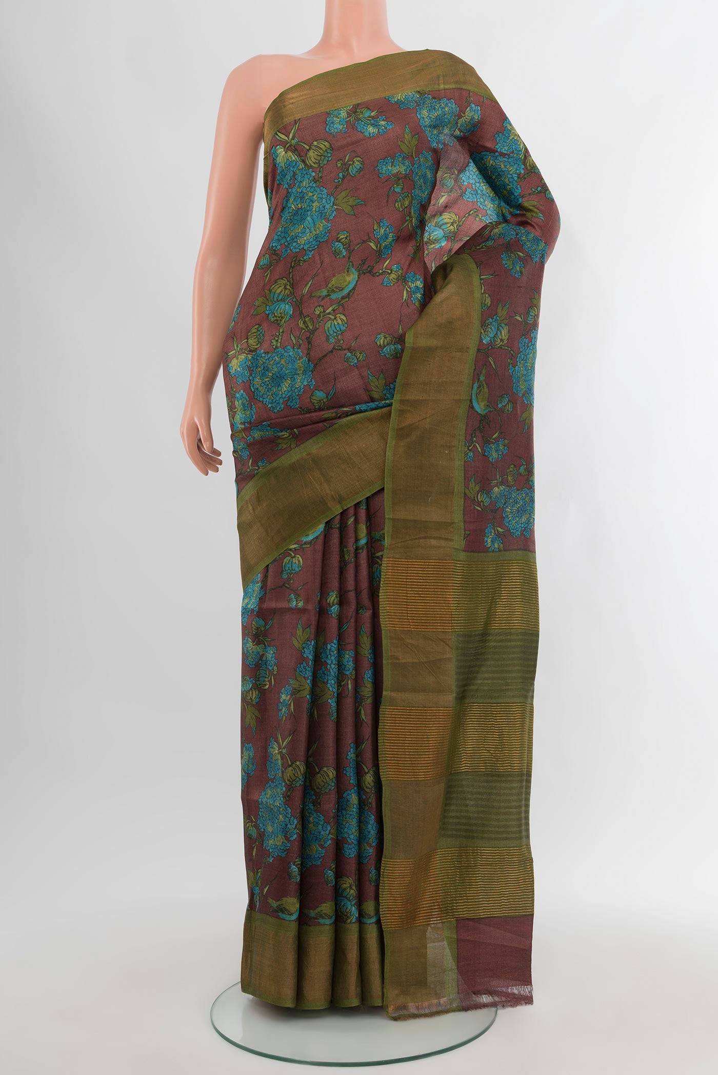 Brown Tussar Silk Saree with Floral Print on the body and Zari Border.  displayed on a mannequin