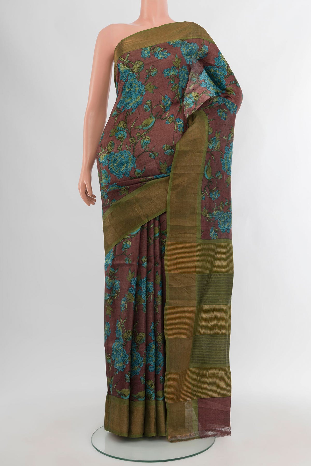 Brown Tussar Silk Saree with Floral Print on the body and Zari Border.  displayed on a mannequin