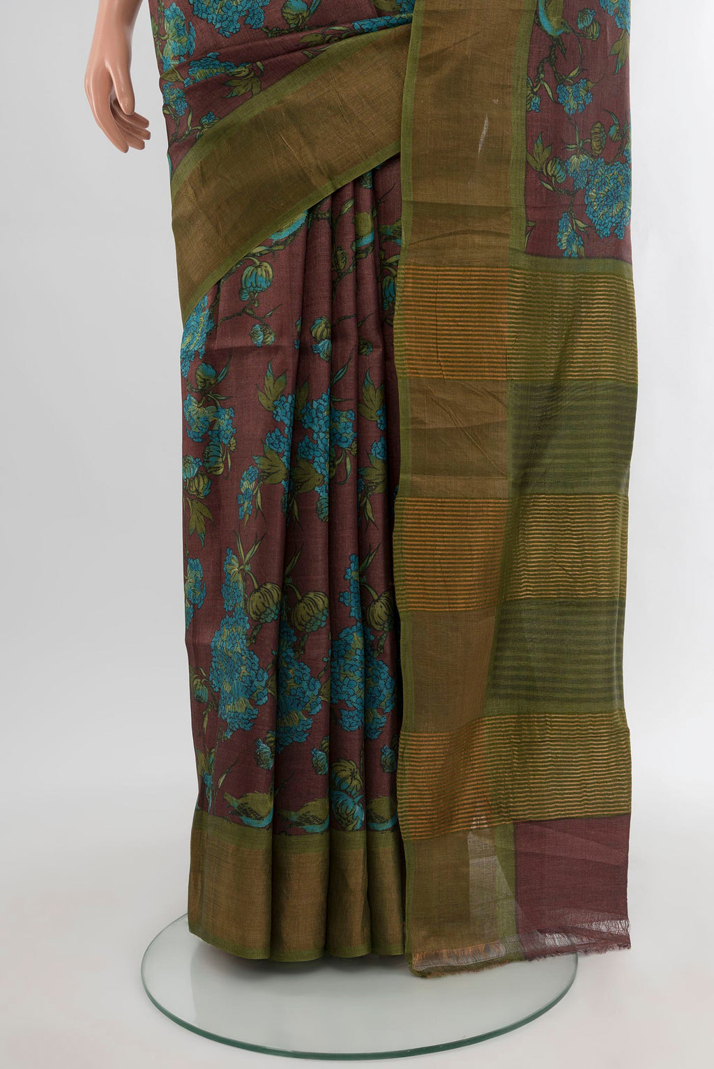 Pleats and pallu of Brown Tussar Silk Saree with Floral Print on the body and Zari Border. 