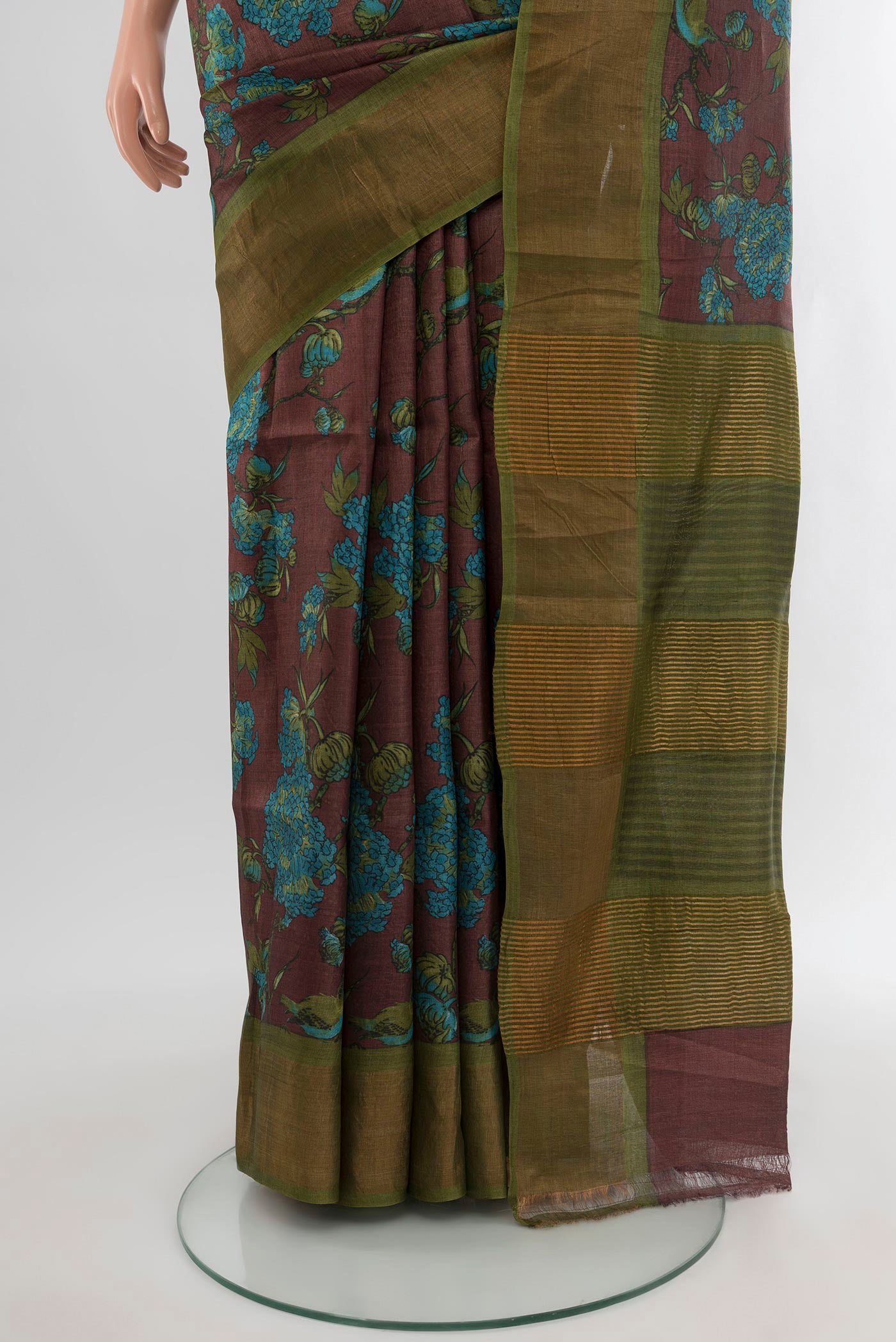 Pleats and pallu of Brown Tussar Silk Saree with Floral Print on the body and Zari Border. 