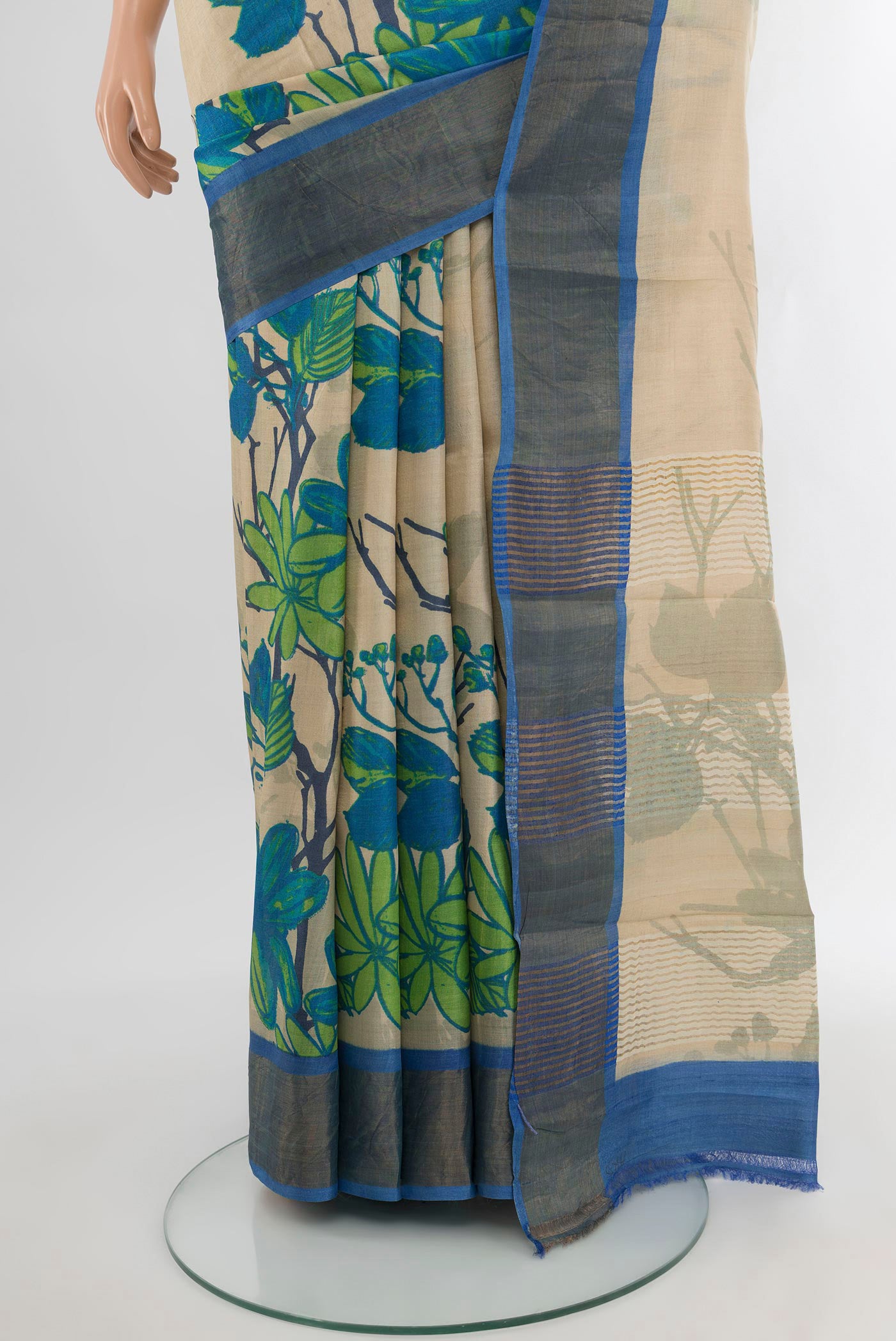 Pleats and pallu of Beige Tussar Silk Saree with Floral Print on the body and Zari Border. 