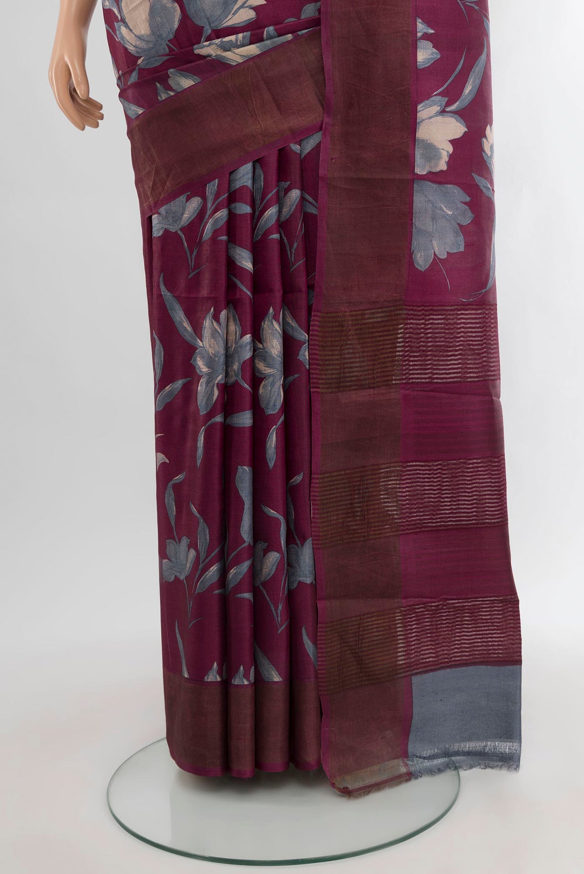 Pleats and pallu of Burgundy Tussar Silk Saree with Floral Print on the body and Zari Border. 