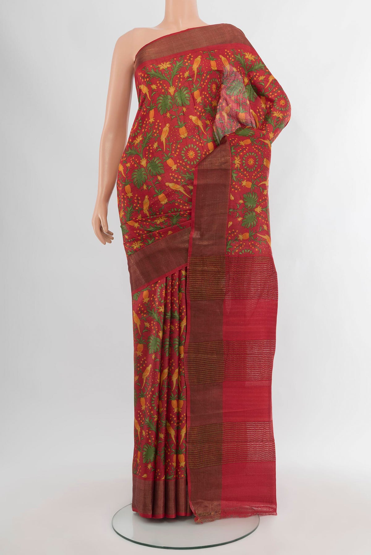 Red Tussar Silk Saree with Floral Print on the body and Zari Border.  displayed on a mannequin