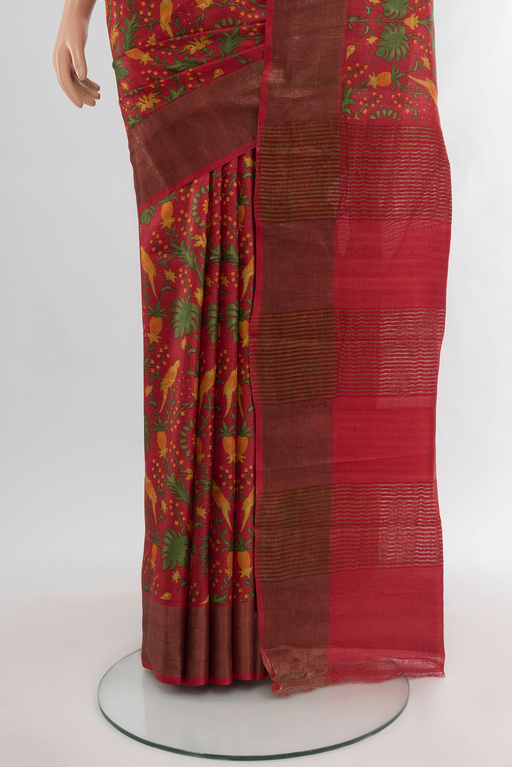 Pleats and pallu of Red Tussar Silk Saree with Floral Print on the body and Zari Border. 