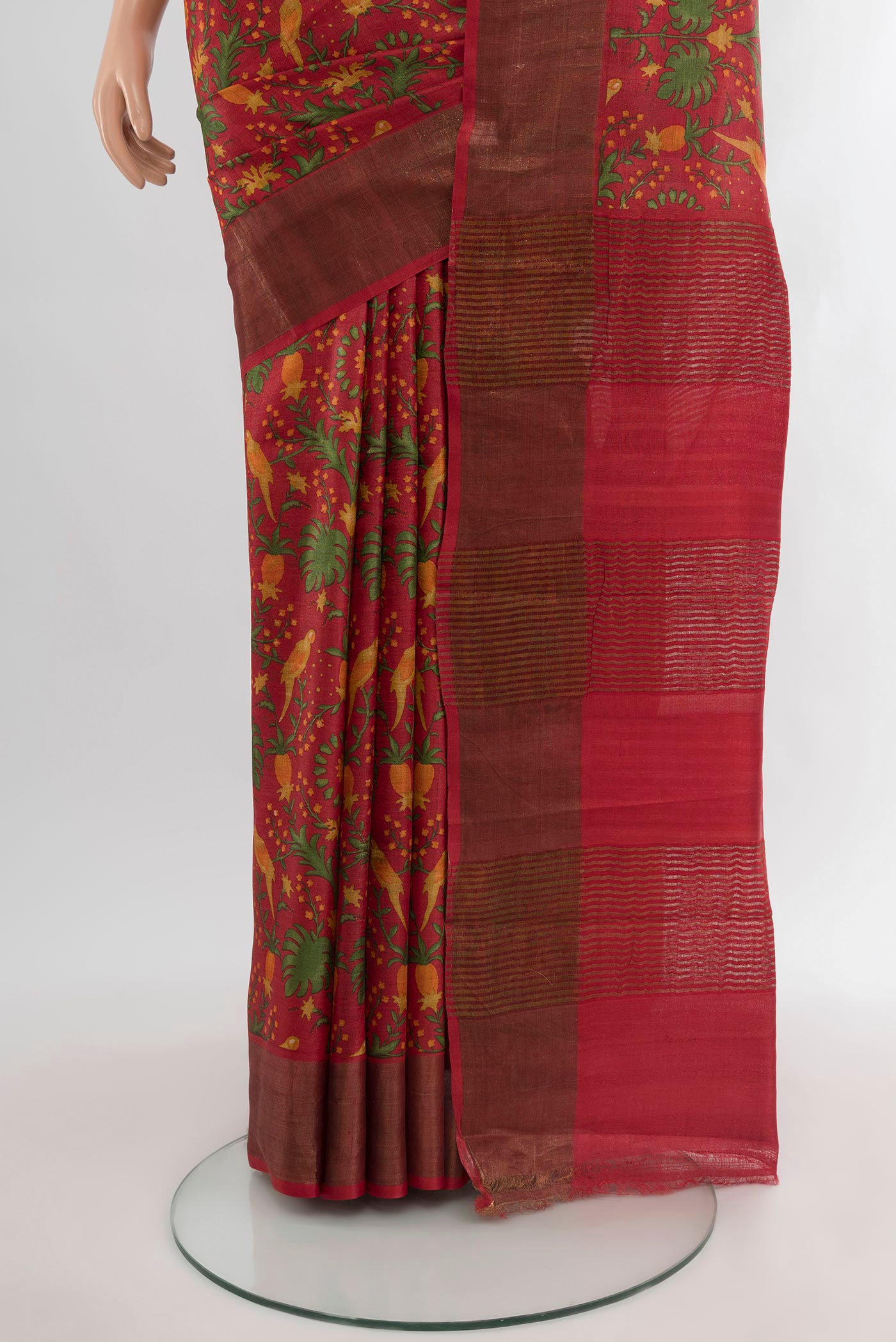 Pleats and pallu of Red Tussar Silk Saree with Floral Print on the body and Zari Border. 