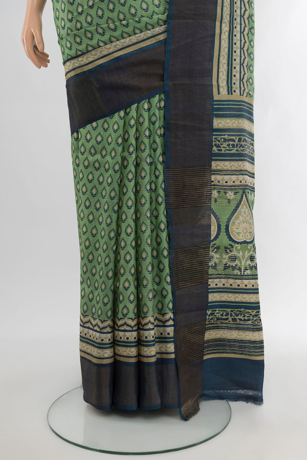 Pleats and pallu of Sage Green Tussar Silk Saree with Floral Print on the body and Zari Border. 